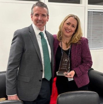 Kyle Crowder presents Senator Baldwin's Excellence in Public Service Award to Meghan Mott, who works for the Senator on the Labor, Health and Human Services and Education Appropriations Subcommittee